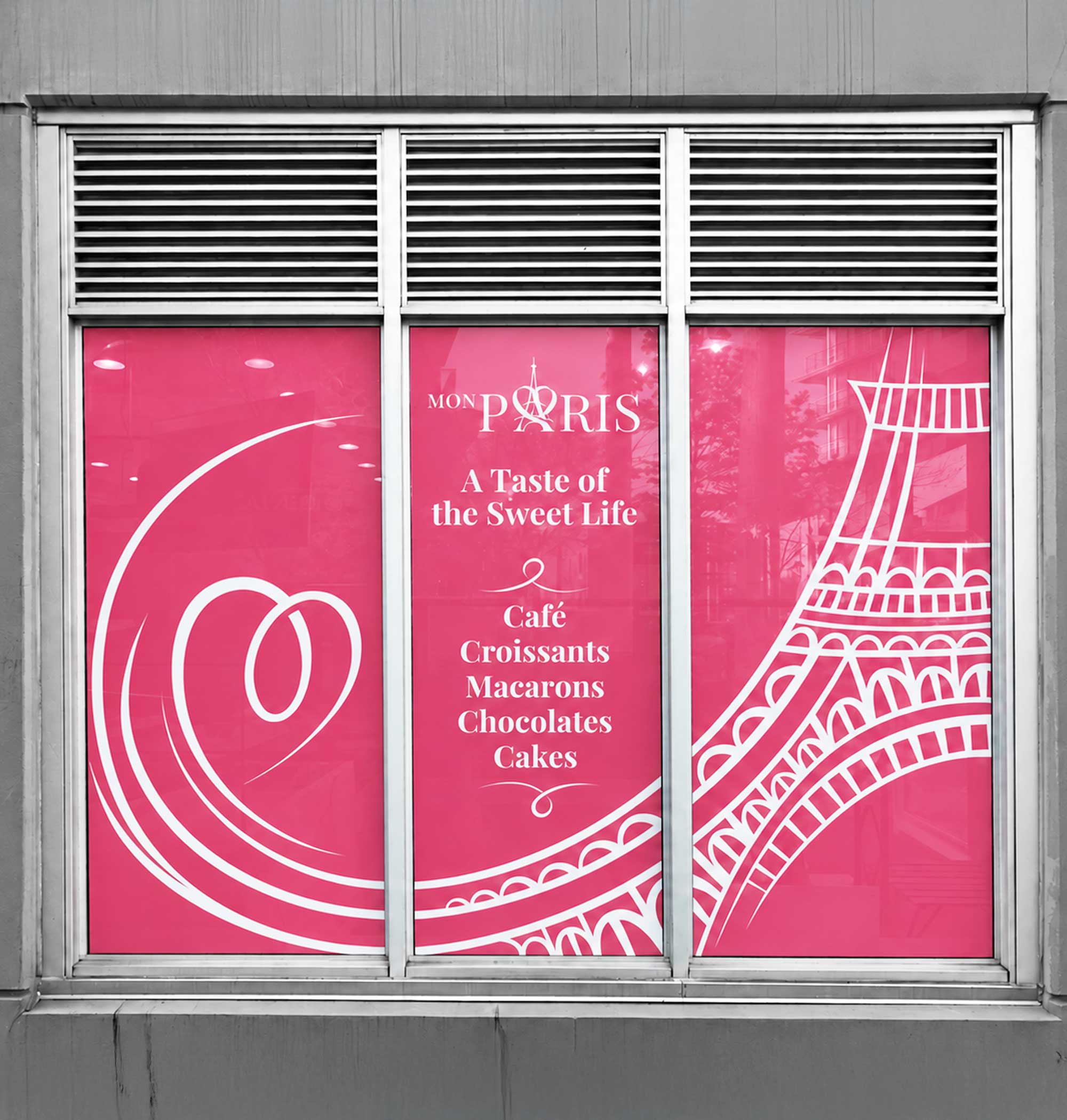 Café window design for Mon Paris Café in Vancouver, with pink vinyl graphics and a white hand-drawn Eiffel Tower illustration.